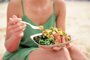 Photo of a Woman Eating Some of the Best Takeout in Myrtle Beach...on the Beach.